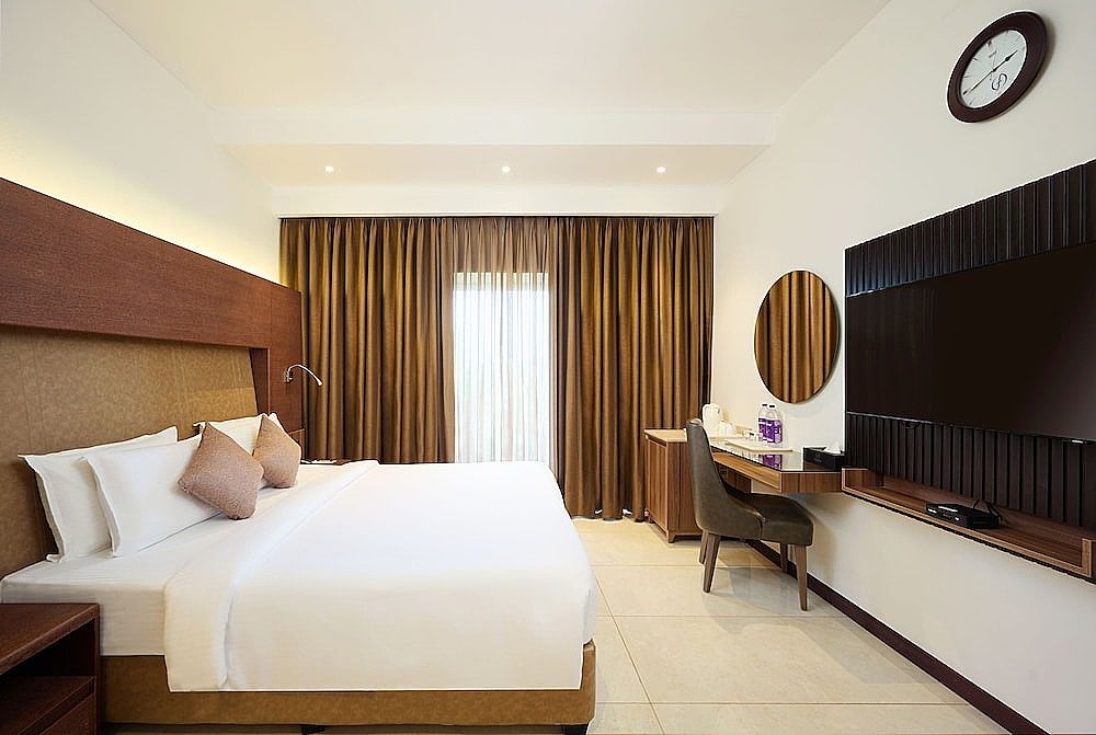 Flora Airport Hotel and Convention Centre Kochi Deluxe king room with complimentary airport transfers