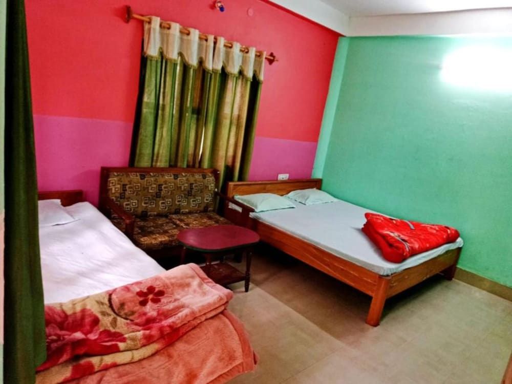 Goroomgo Green Gold Resort Lataguri Deluxe Quadruple Room