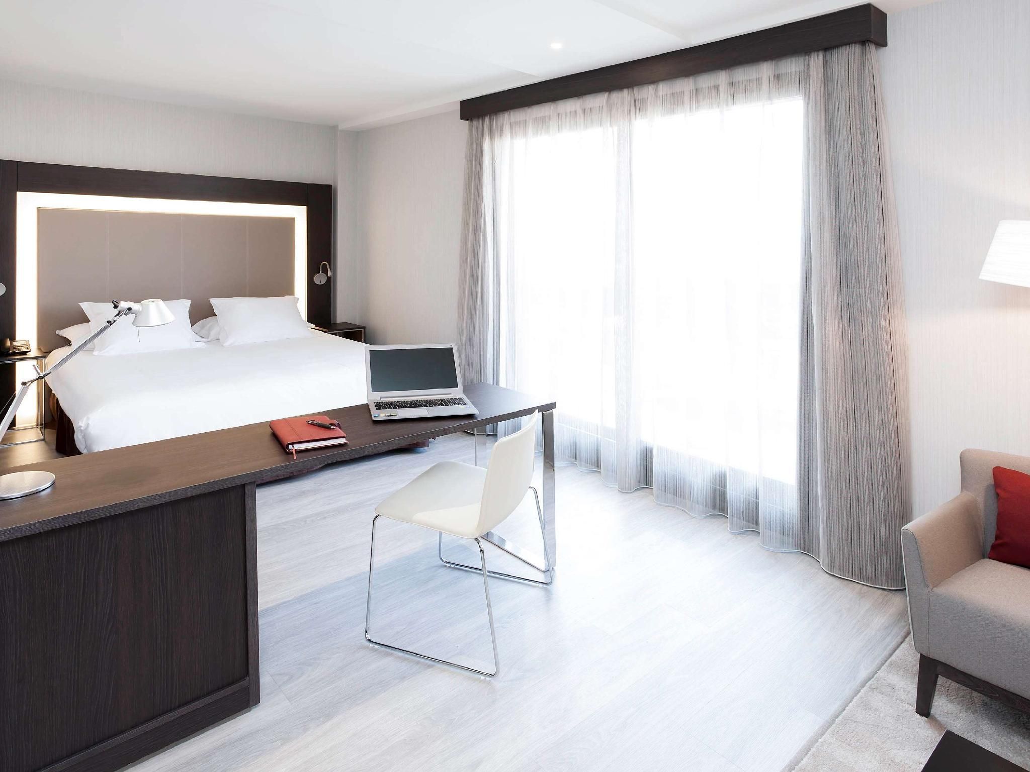 Novotel Madrid Center Standard Room with queen-size bed and sofa bed.