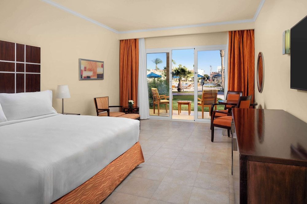 DoubleTree by Hilton Sharm El Sheikh - Sharks Bay Resort deluxe room, king bed, pool view, mountainside