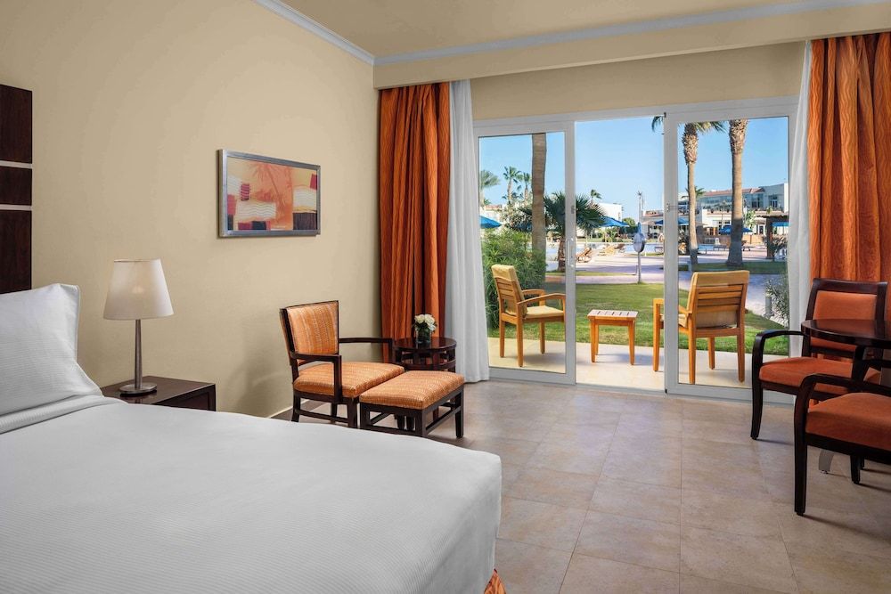 DoubleTree by Hilton Sharm El Sheikh - Sharks Bay Resort deluxe room, king bed, pool view, mountainside 2