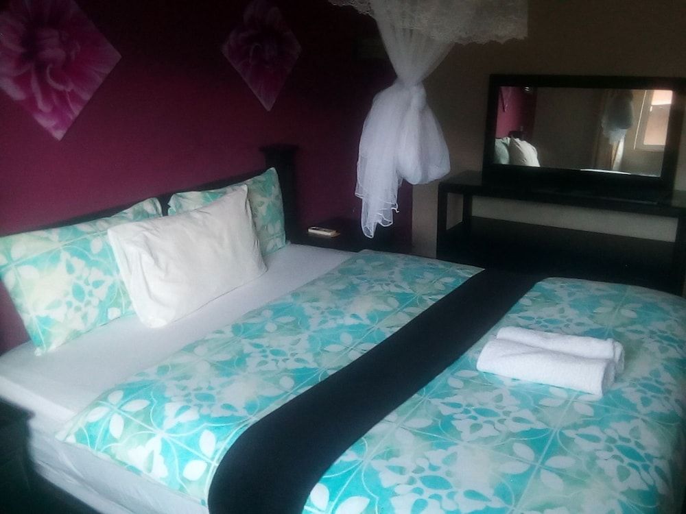 Royal Olympia Lodges and Safaris Deluxe Room 3