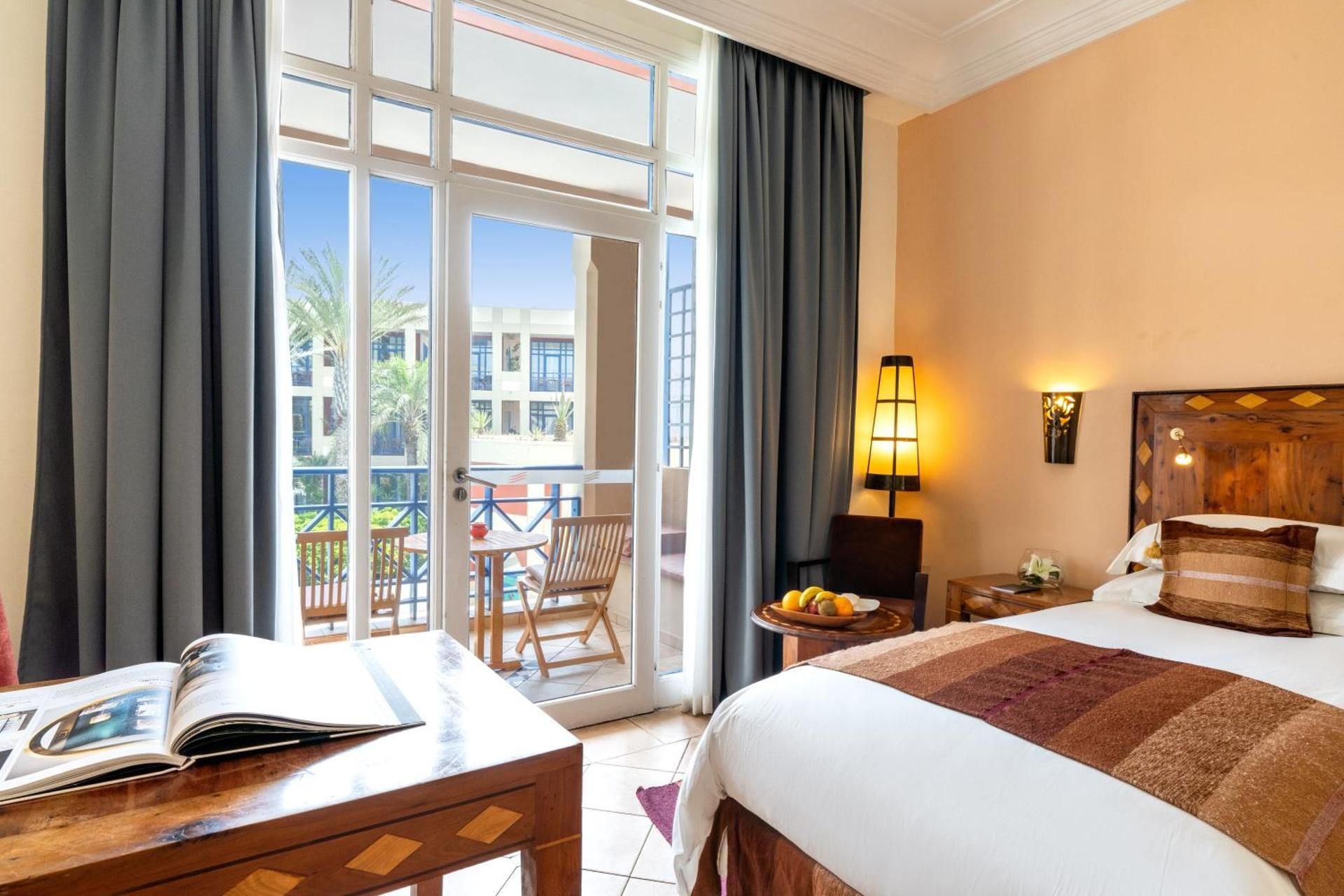 Executive Suite with a king-size bed and view of the swimming pool
