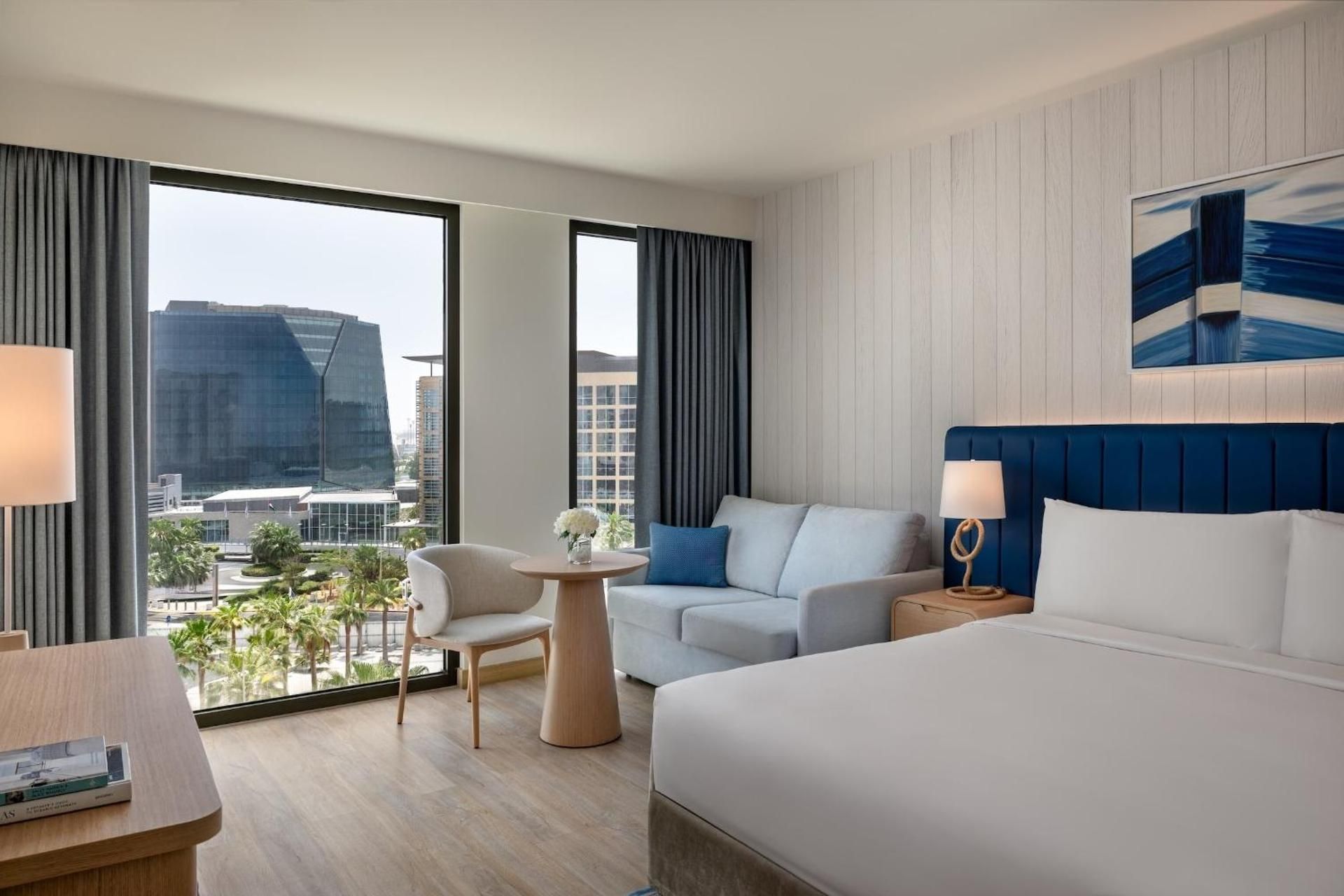 One-Bedroom Suite with Plaza View and Living/Dining Area - Theme Park