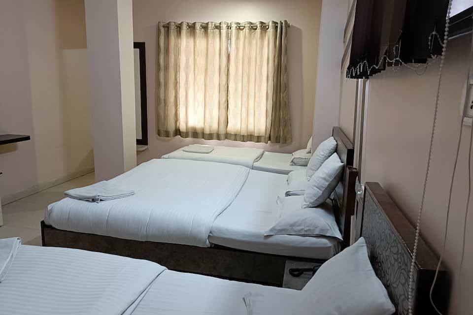 Hotel Satyam Four Bed Deluxe Room - AC