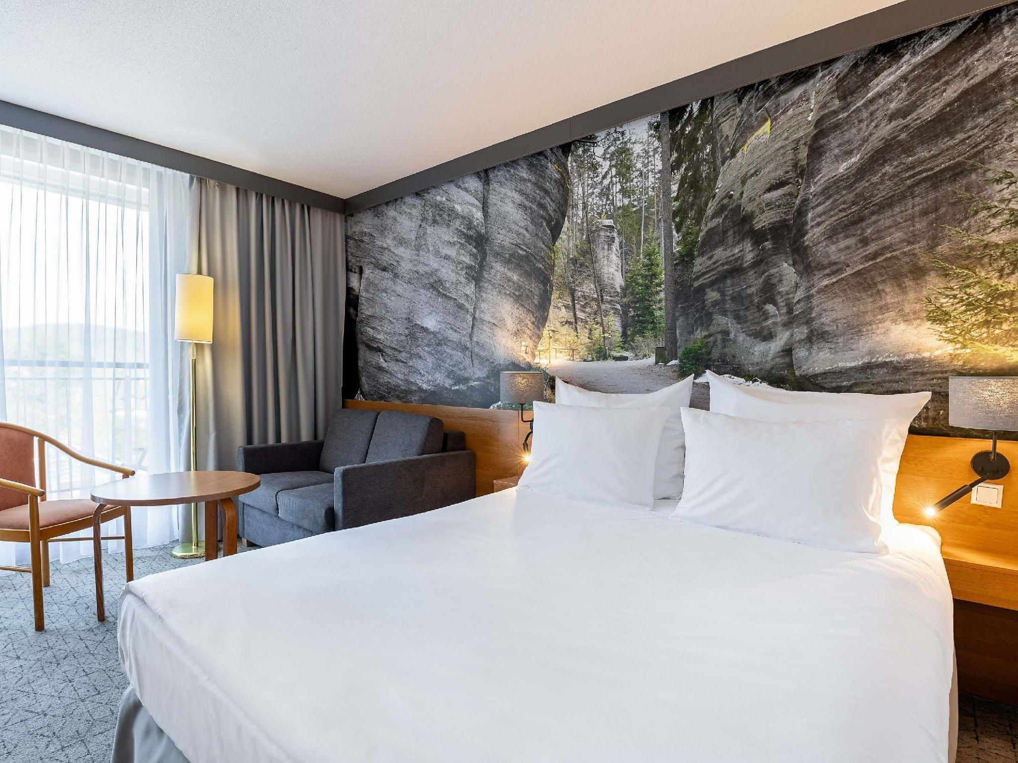 Air-conditioned standard room with queen size b ed and sofa