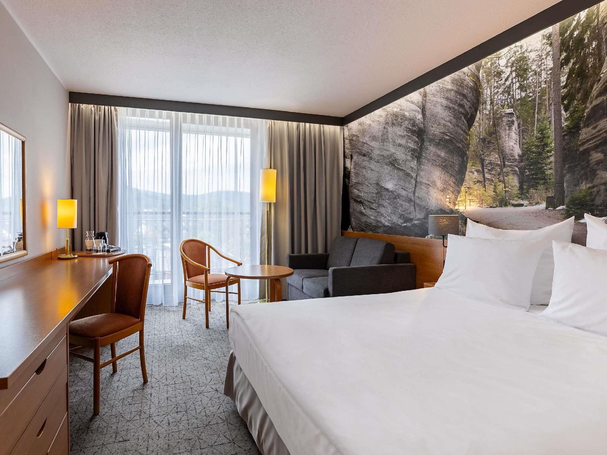 Air-conditioned standard room with queen size b ed and sofa
