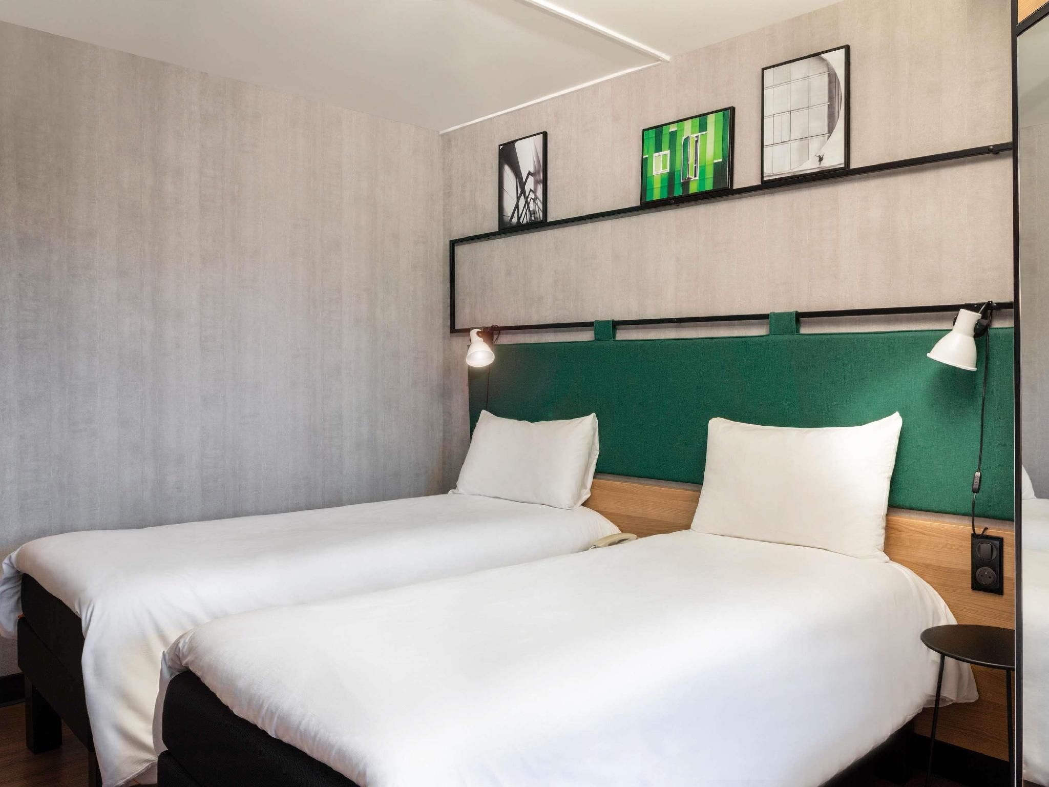 Room With Two Single Beds Equipped With The Latest Bedding