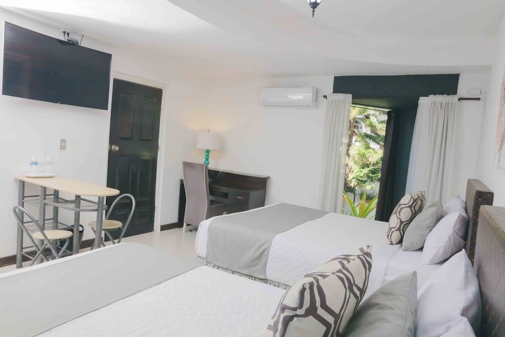 Deluxe Quadruple Room, 2 Queen Beds, Private Bathroom, Courtyard View
