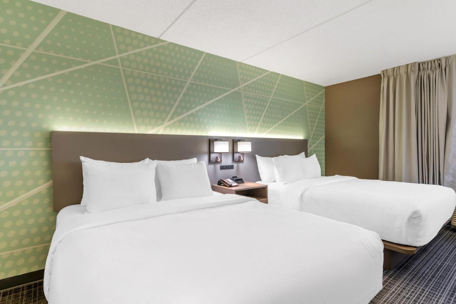 Efficiency Quadruple Room with Two Queen Beds and Roll-In Shower - Non Smoking