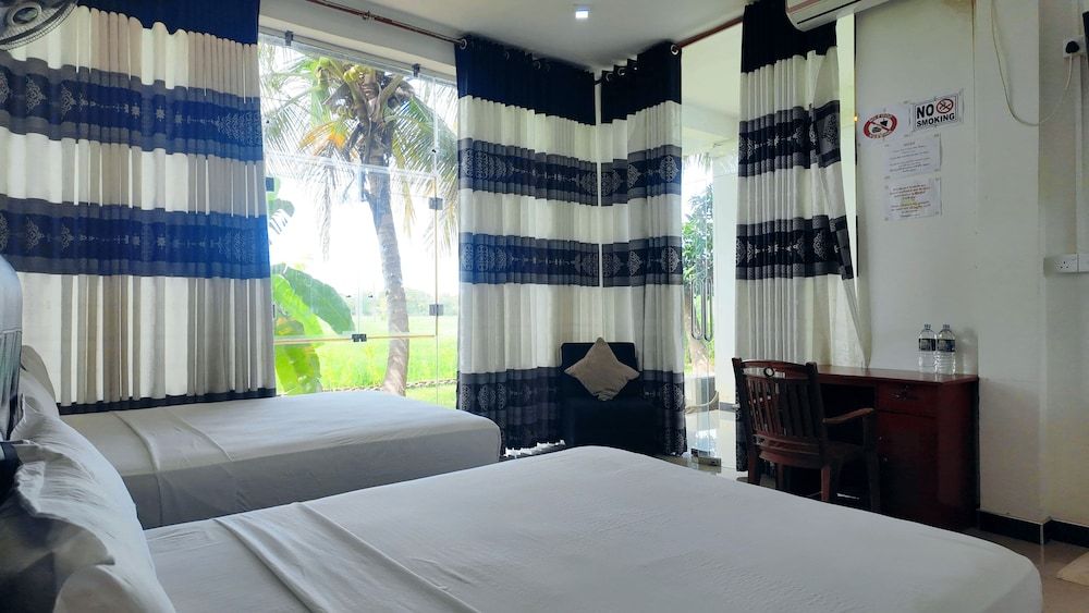 Deluxe Quadruple Room, 2 Queen Beds, Balcony, Garden View