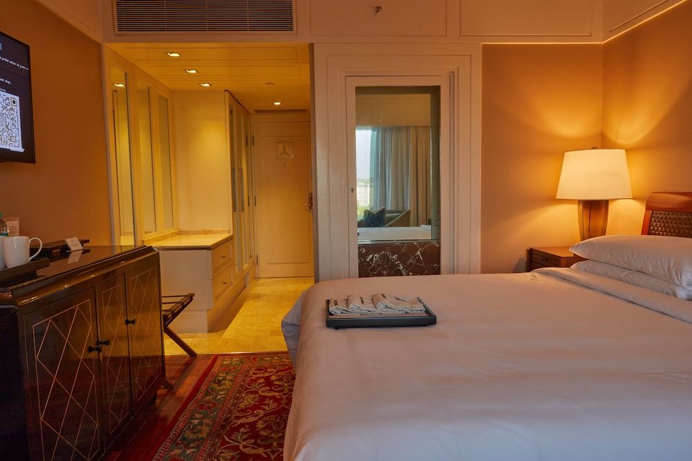 The Leela Mumbai Premier Room Pool View With 1+1 Happy hours are from 5pm to 7pm at 6 degrees on selected brands 5