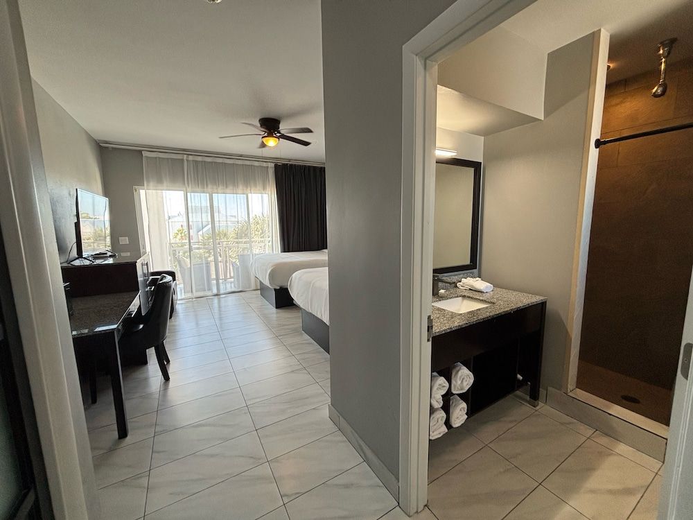 The All New Grace Bay Suites Family Room, 2 Queen Beds, Balcony, Pool View