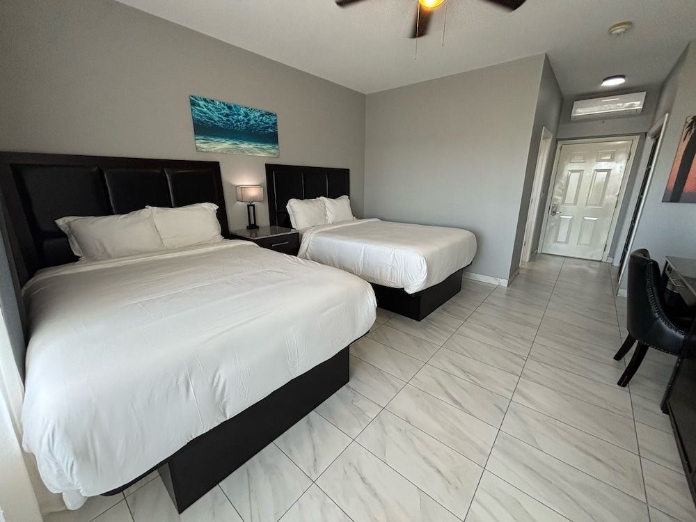 The All New Grace Bay Suites Family Room, 2 Queen Beds, Balcony, Pool View 2