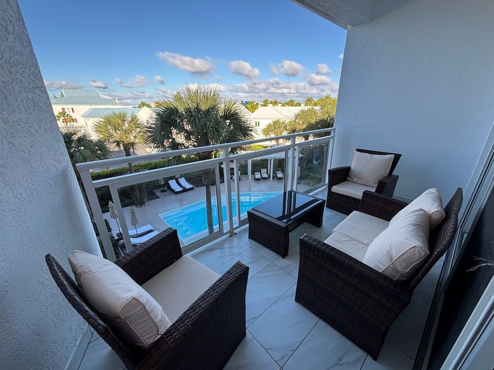 The All New Grace Bay Suites Family Room, 2 Queen Beds, Balcony, Pool View 4