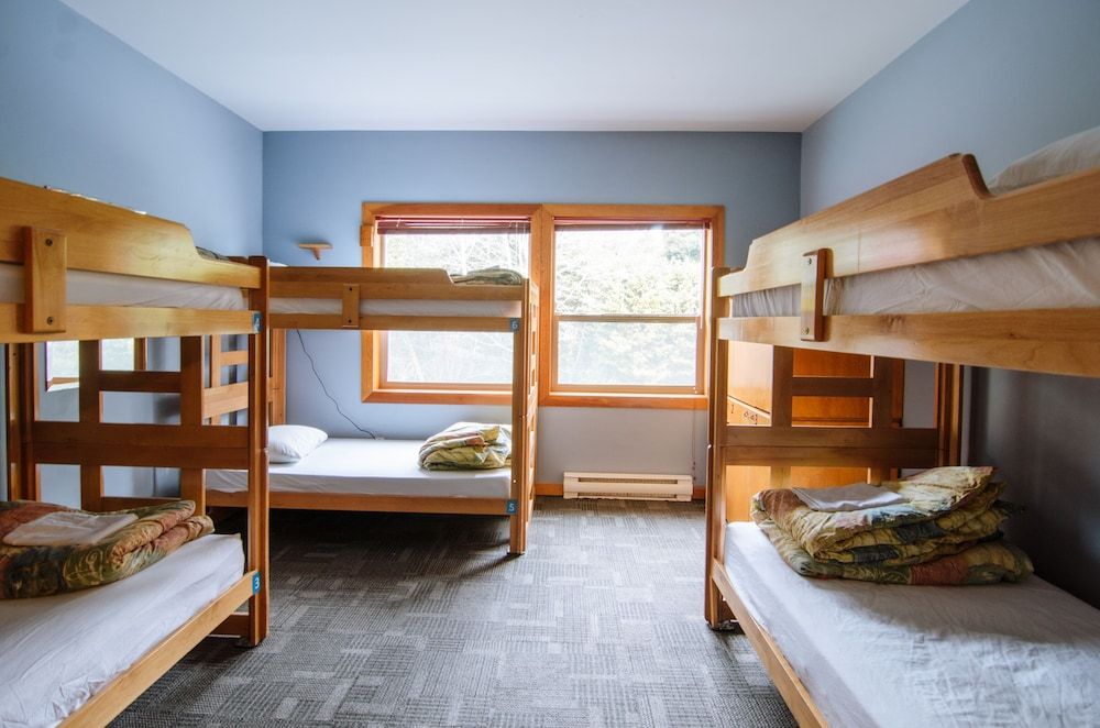 Private room with 6 single beds and shared bathrooms