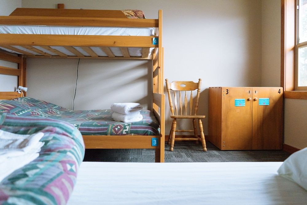Private room with 4 single beds and shared bathrooms