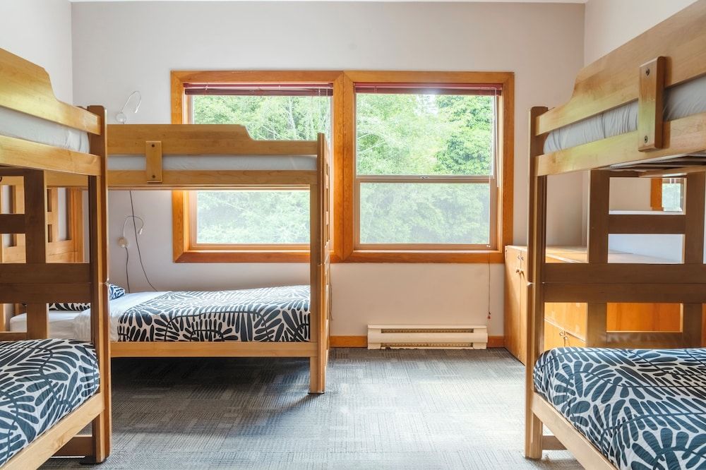 Private room with 6 single beds and shared bathrooms