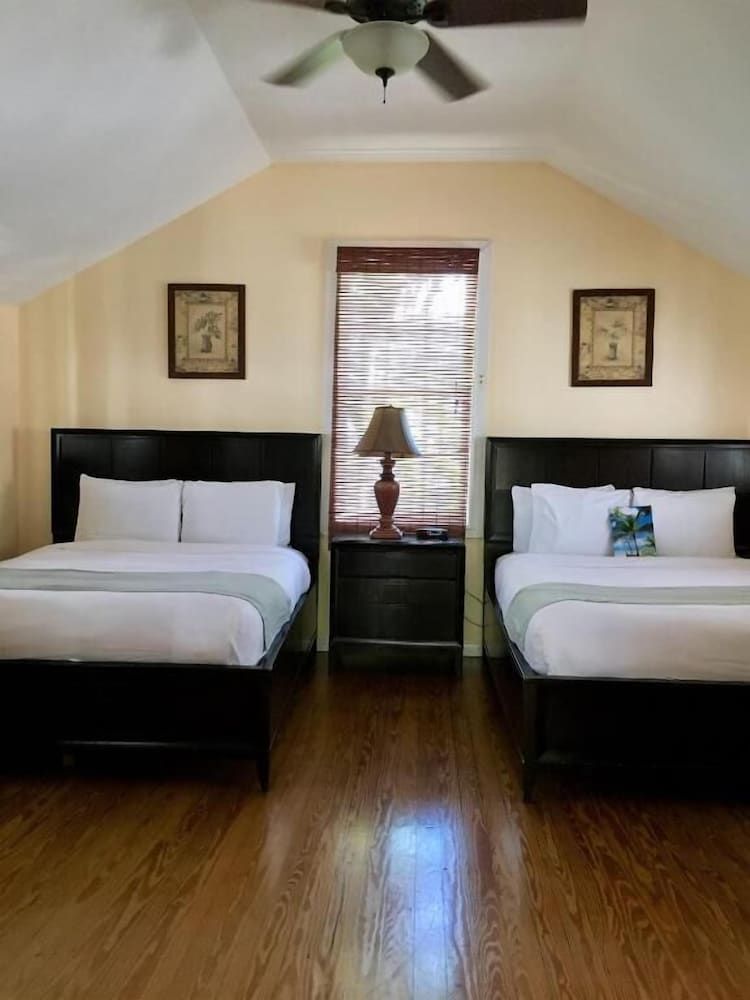 Douglas House Sugar Palm Superior Suite, 2 Queen beds, living area, Balcony, Pool View, Garden Area 2nd Floor Stai