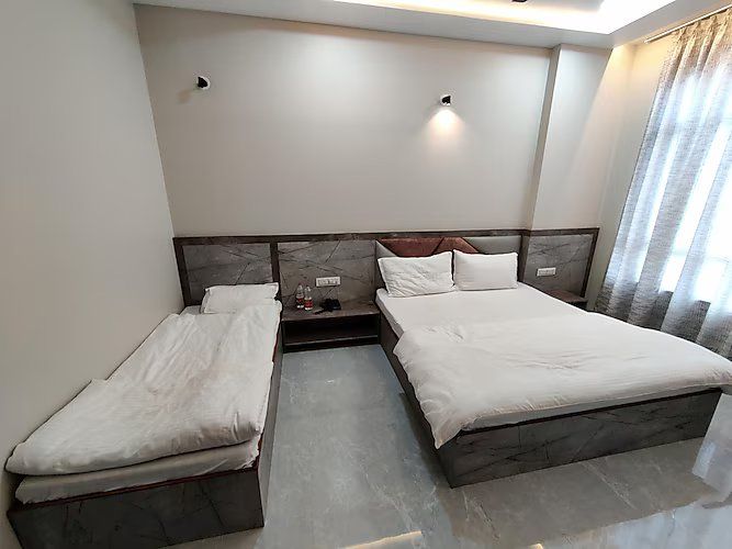 Hotel Ashirwad Deluxe Triple Room ( 1 Double Bed + 1 Single Bed )