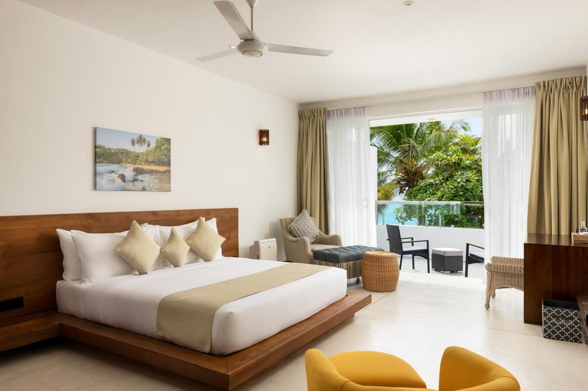 Deluxe Double Room with Balcony and Sea View with homemade Sorbet, a tropical evening mocktail, local snacks with tea/coffee, and a dining experience by the white sands