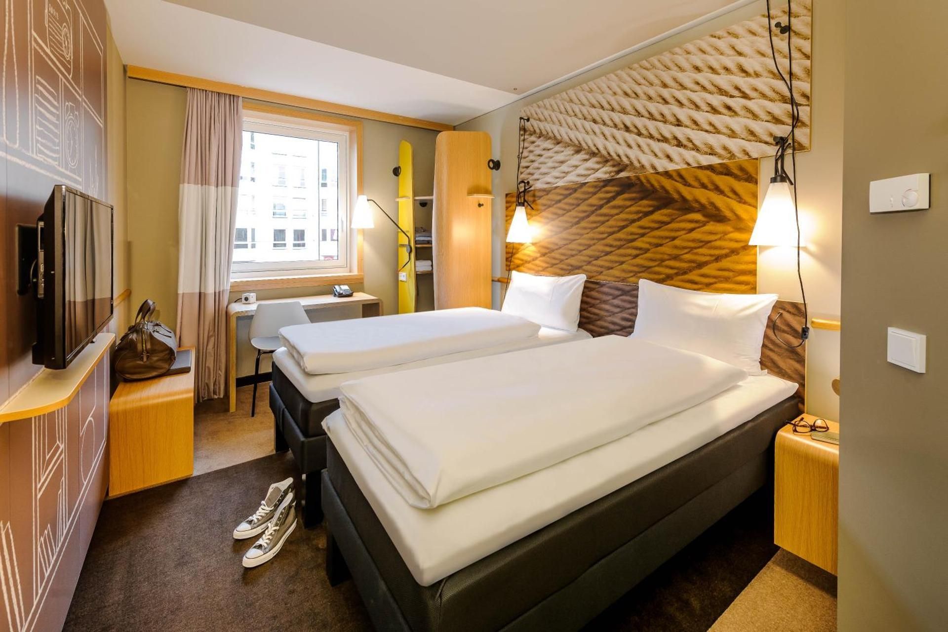 Room with 2 single beds equipped with the new b edding