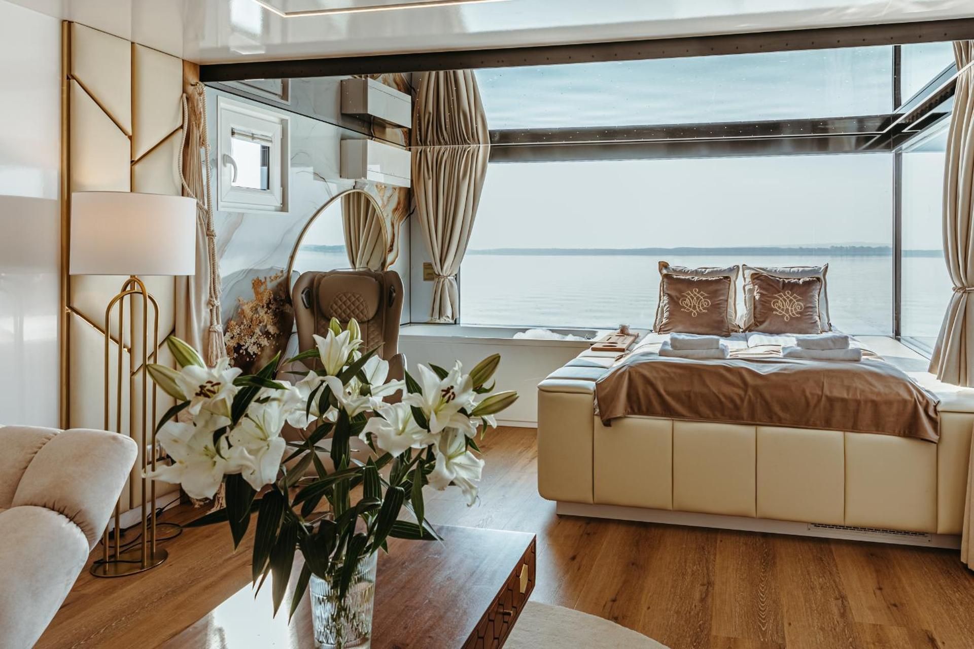 House on water with bed and jacuzzi by the window, sauna, massage chair and roof terrace