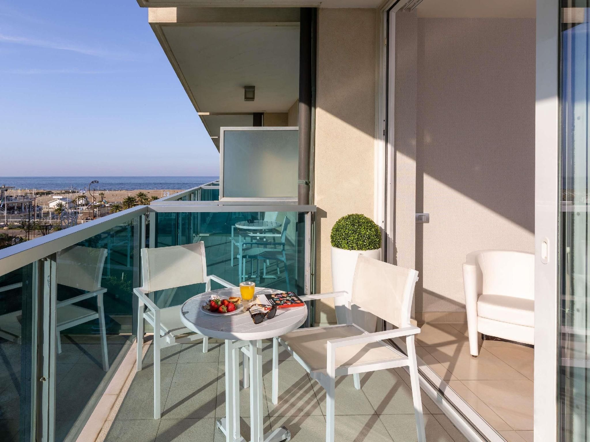 Superior Room with double bed and sofa bed and a pleasant balcony with side sea view