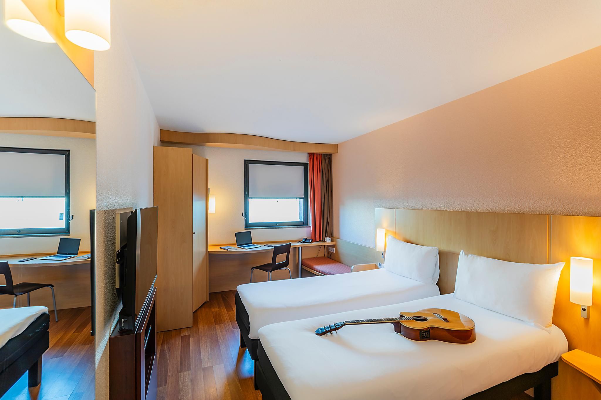 Room with 2 single beds equipped with the new b edding