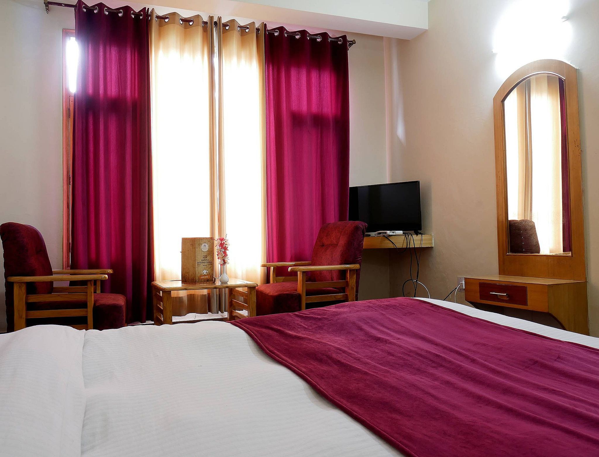 New Ambika International Deluxe Room