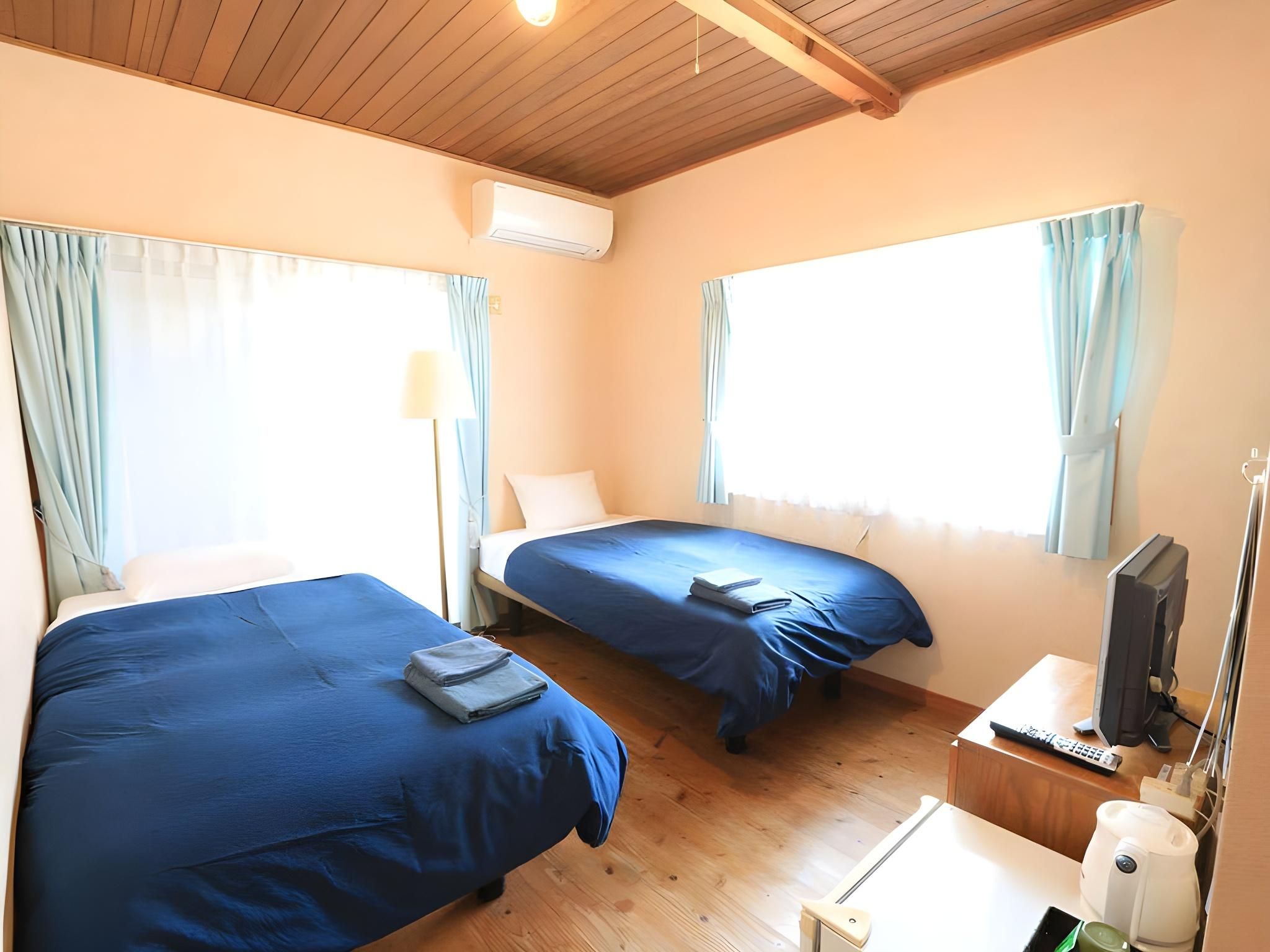 Log house twin room with shower and toilet