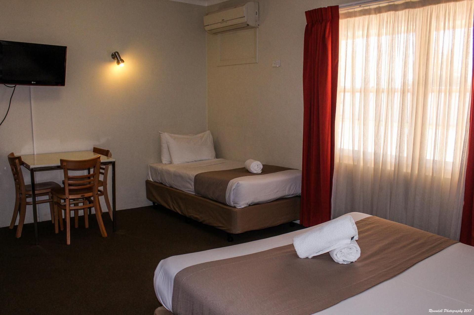 Downstairs Room with a Queen and 3 Single Beds