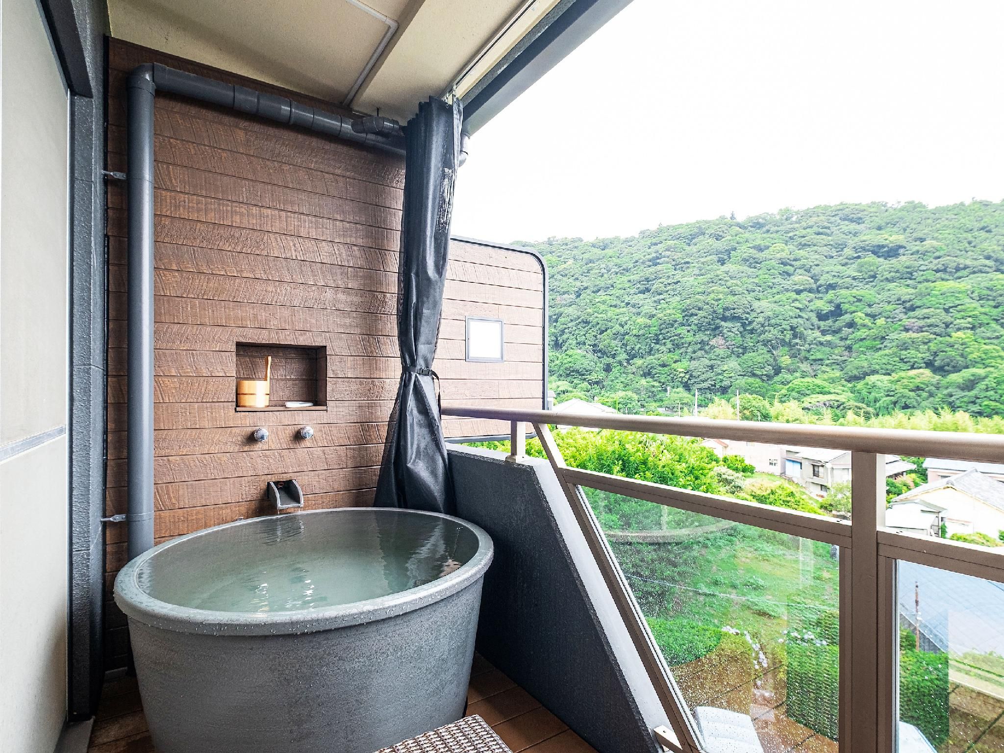 Modern Japanese-Western Room with Open-Air Rock Bath