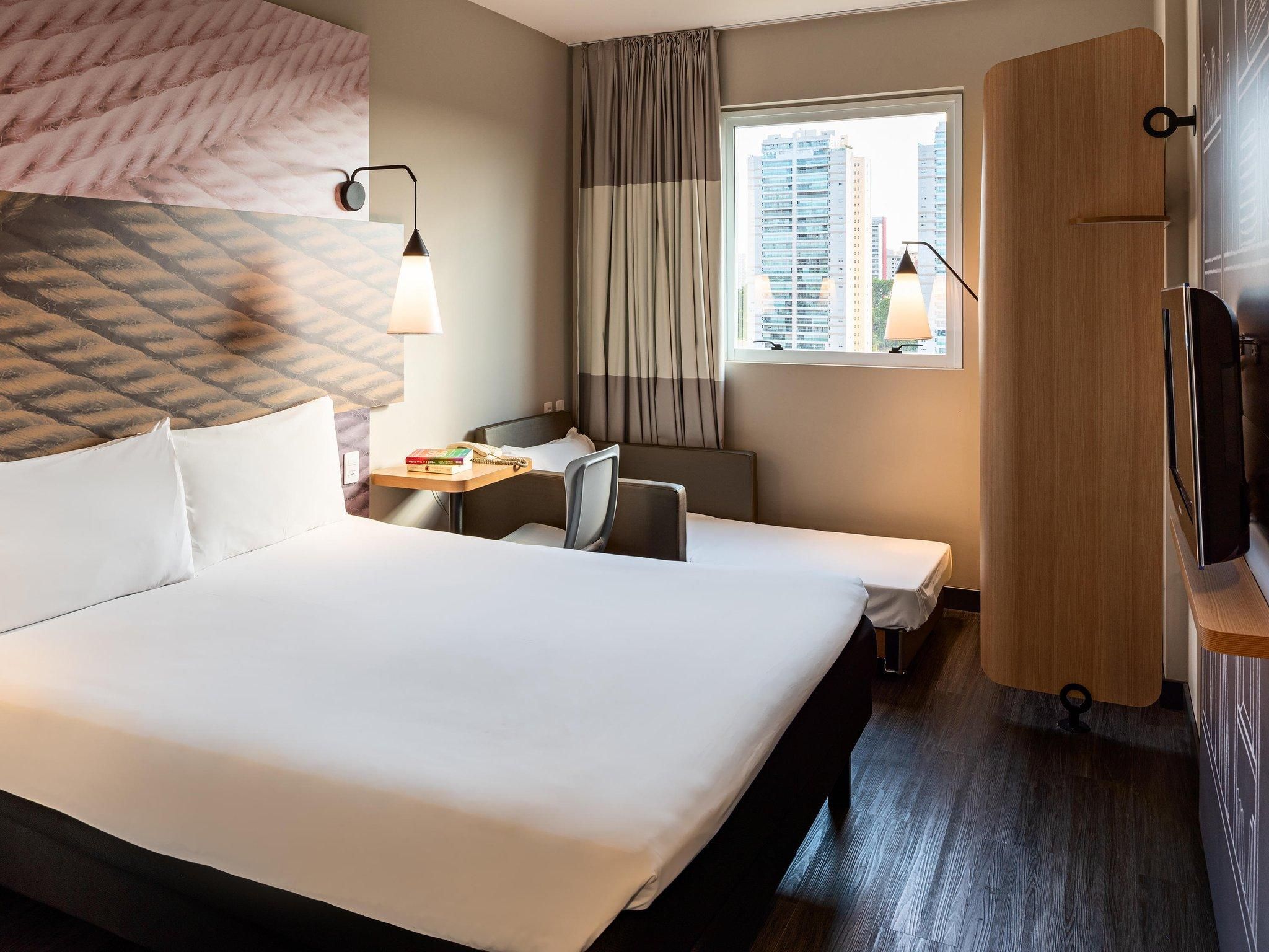 Room with one double bed and one extra bed