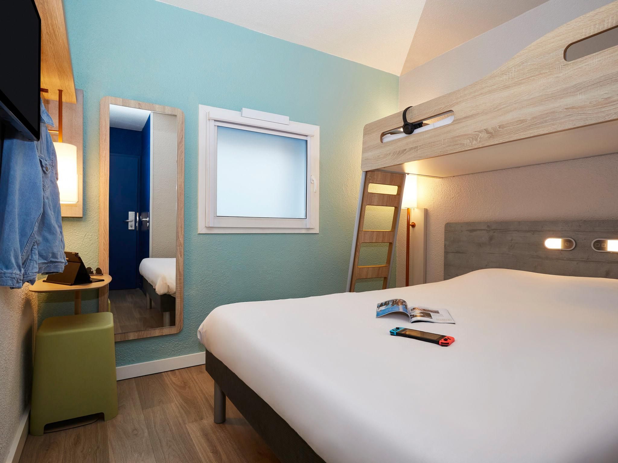Triple - Room with a large bed and a bunk bed.
