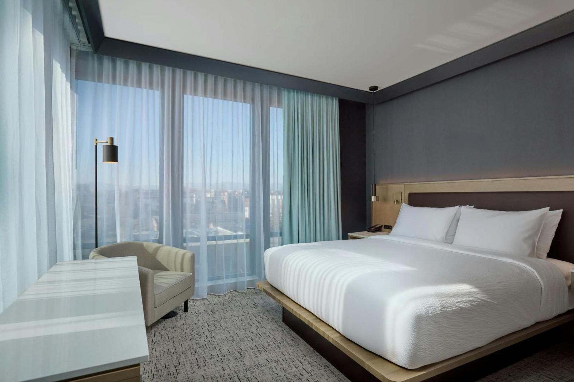 One-Bedroom Junior King Suite with Sofa Bed and Stadium View - Hearing Accessible