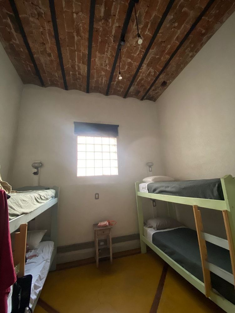 4 beds female dormitory with shared bathroom and window